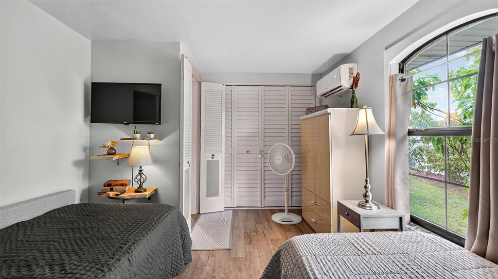 6499 Nebula Street Weeki Wachee, FL 34613 - Photo 28 of 54 a bedroom with a bed and a flat tv screen