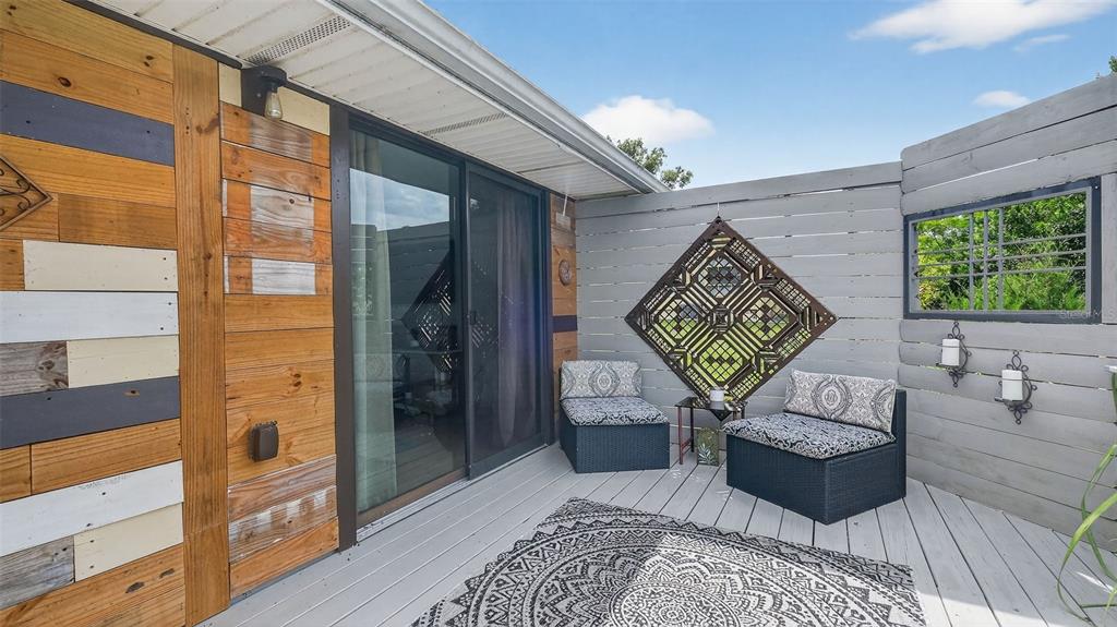 6499 Nebula Street Weeki Wachee, FL 34613 - Photo 32 of 54 a balcony view with a couch and wooden floor