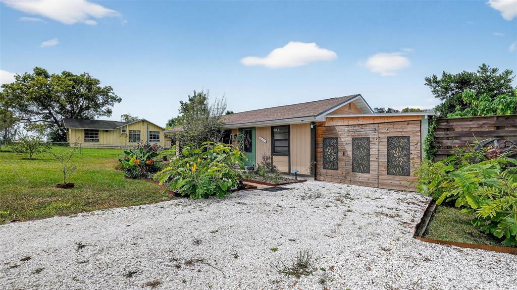 6499 Nebula Street Weeki Wachee, FL 34613 - Photo 49 of 54 a front view of a house with a garden
