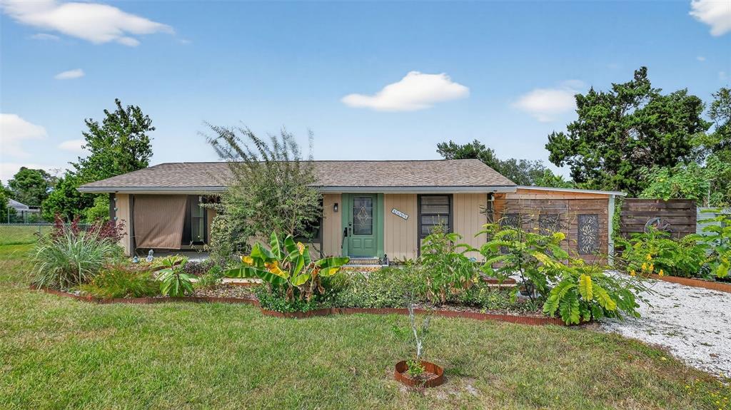 6499 Nebula Street Weeki Wachee, FL 34613 - Photo 50 of 54 a view of a house with a yard and a garden