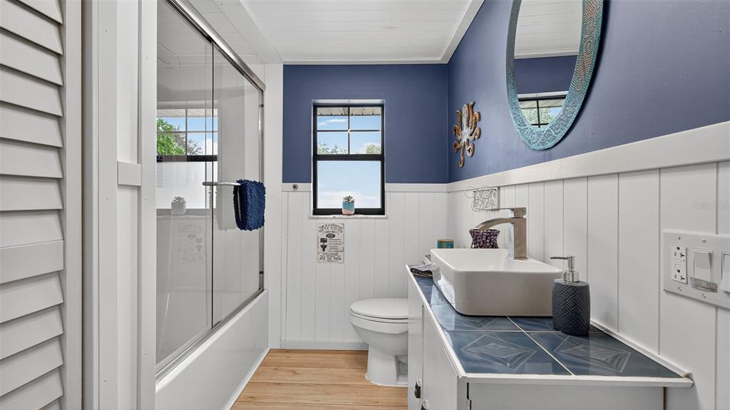 6499 Nebula Street Weeki Wachee, FL 34613 - Photo 5 of 54 a bathroom with a toilet a sink and a mirror