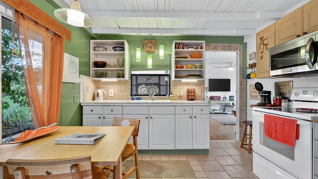 6499 Nebula Street Weeki Wachee, FL 34613 - Photo 8 of 54 a kitchen with stainless steel appliances kitchen island granite countertop a sink and cabinets
