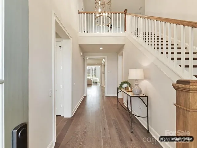 a view of a hallway with a couch and a dresser in a room