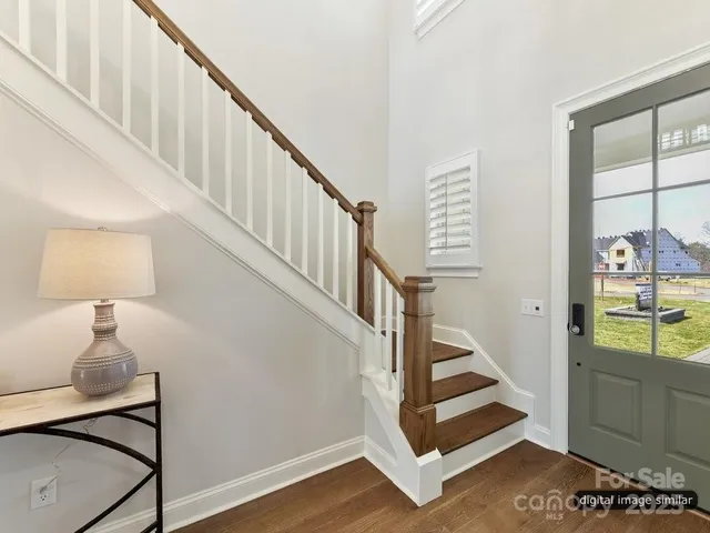 a living room with furniture a flat screen tv and a chandelier