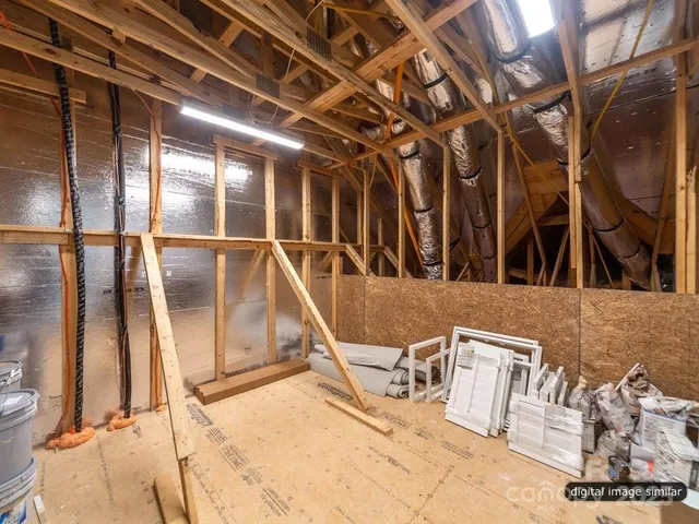 a living room with furniture a clock and a large window