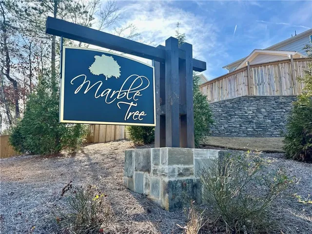 an aerial view of residential houses with outdoor space and street view