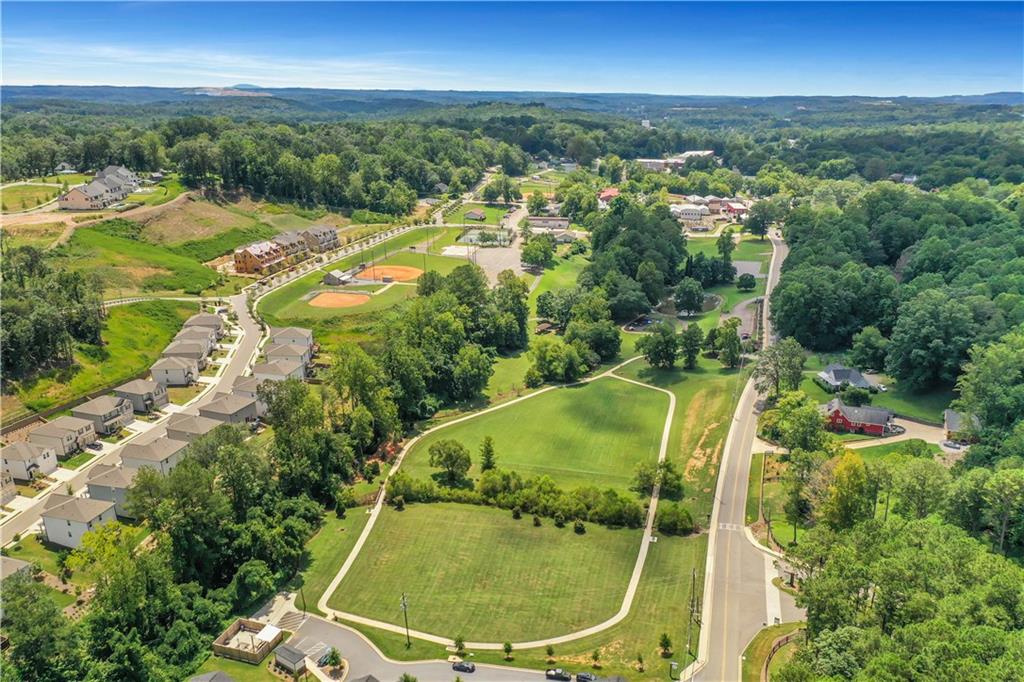 162 Marble Tree Way Ball Ground, GA 30107 - Photo 33 of 38 an aerial view of residential houses with outdoor space and trees