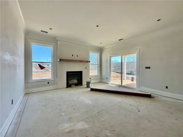 a view of empty room with a fireplace