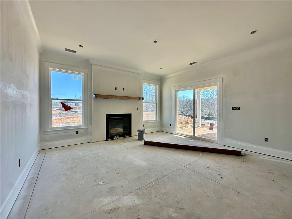 162 Marble Tree Way Ball Ground, GA 30107 - Photo 5 of 38 a view of empty room with a fireplace