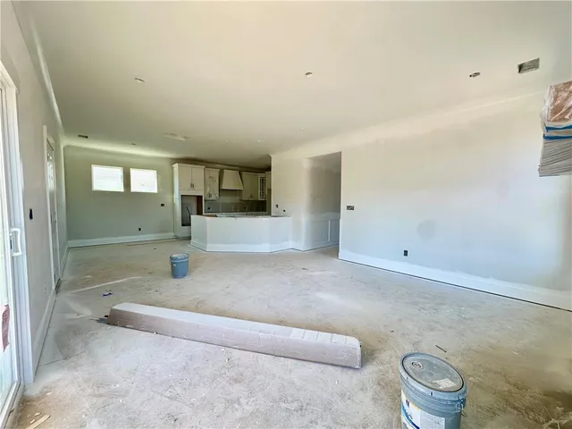 a view of kitchen with stainless steel appliances granite countertop refrigerator sink and cabinets