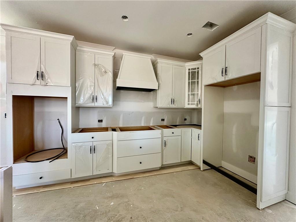 162 Marble Tree Way Ball Ground, GA 30107 - Photo 8 of 38 a kitchen with white cabinets and refrigerator