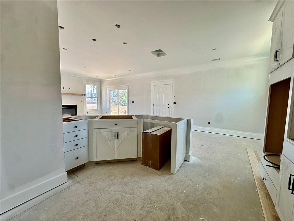 162 Marble Tree Way Ball Ground, GA 30107 - Photo 9 of 38 a room with a stove and a refrigerator in it