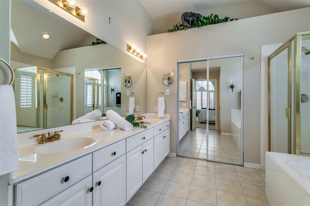 14596 Blueberry Court Addison, TX 75001 - Photo 19 of 32 Bathroom featuring double vanity, a shower stall, a bath, light tile patterned flooring, and connected bathroom