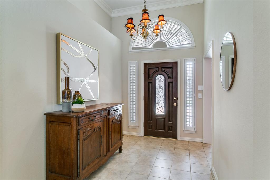 14596 Blueberry Court Addison, TX 75001 - Photo 2 of 32 Entrance foyer featuring crown molding, suspended lighting, light tile patterned floors, and a high ceiling