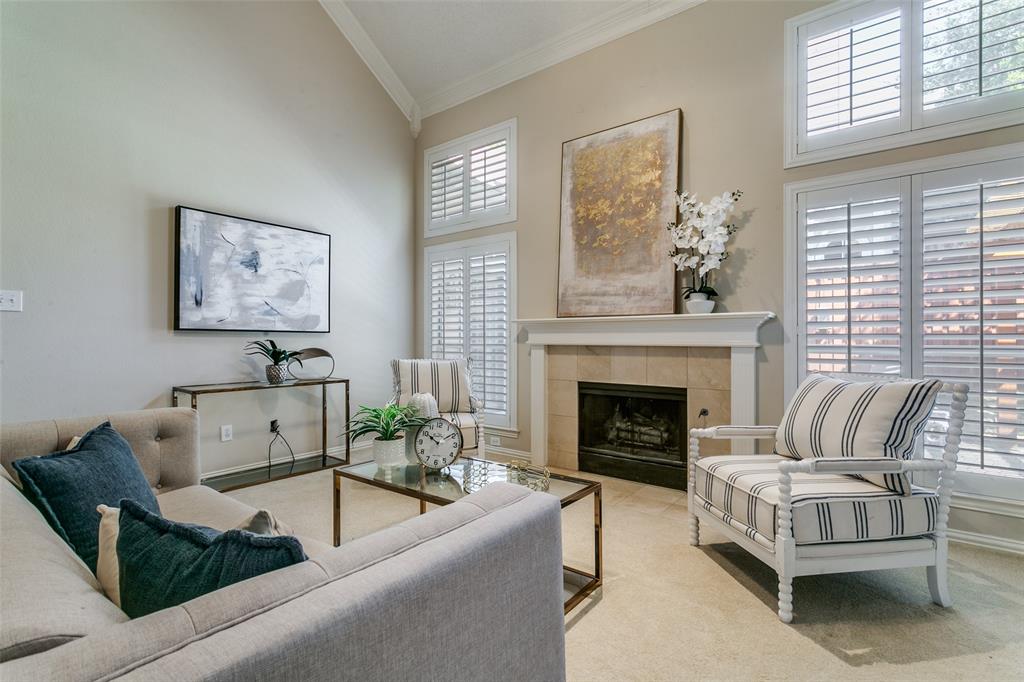 14596 Blueberry Court Addison, TX 75001 - Photo 5 of 32 Living area with a tiled fireplace, ornamental molding, carpet, and vaulted ceiling