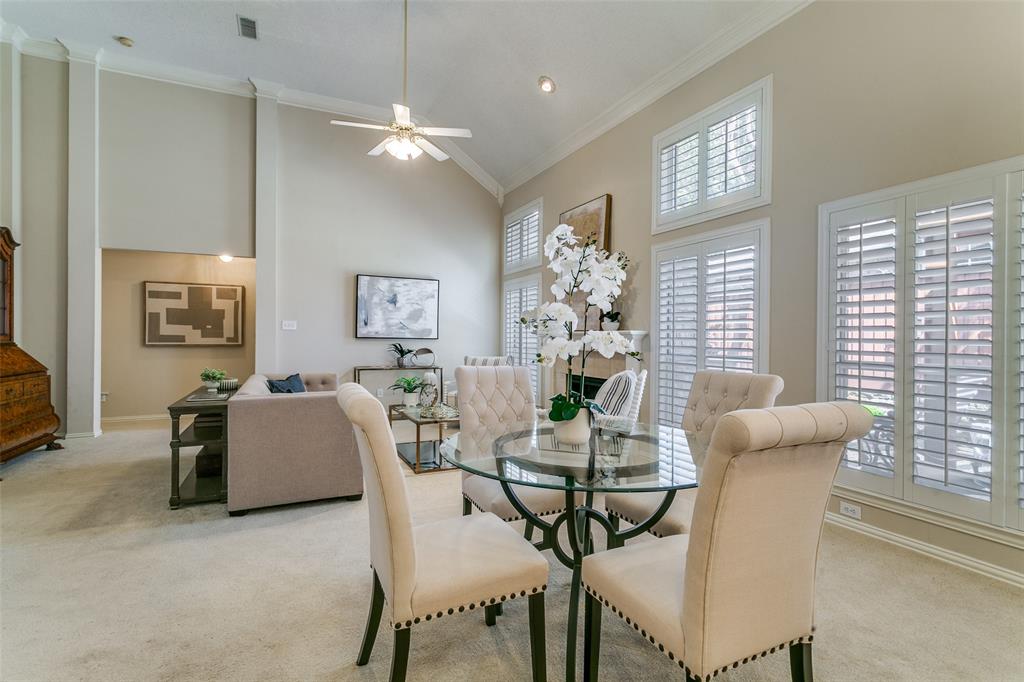 14596 Blueberry Court Addison, TX 75001 - Photo 6 of 32 Dining space with crown molding, ceiling fan, vaulted ceiling, carpet, and a fireplace