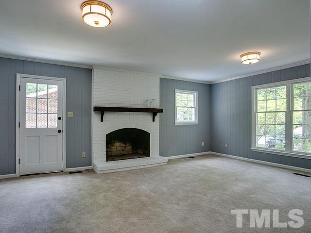 1937 Fountain Ridge Road Chapel Hill, NC 27517 - Photo 16 of 24 an empty room with windows fireplace and fans