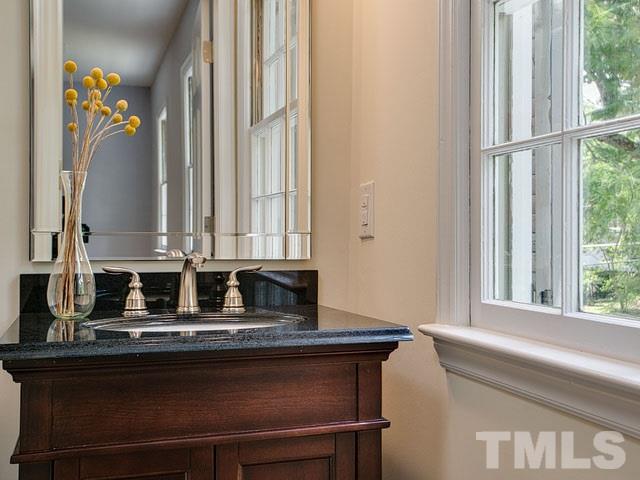 1937 Fountain Ridge Road Chapel Hill, NC 27517 - Photo 19 of 24 a bathroom with a granite countertop sink and a mirror