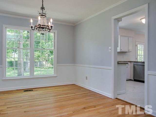 1937 Fountain Ridge Road Chapel Hill, NC 27517 - Photo 6 of 24 a view of an empty room with a window and wooden floor