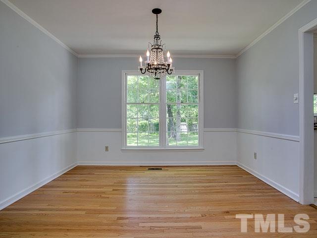1937 Fountain Ridge Road Chapel Hill, NC 27517 - Photo 7 of 24 a view of an empty room with wooden floor and a window