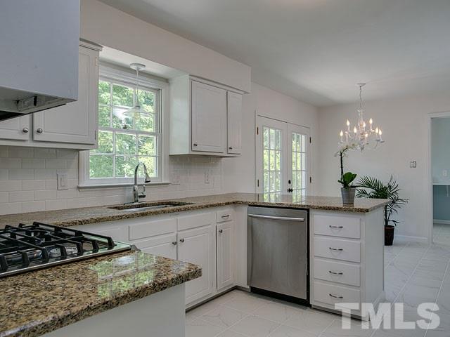 1937 Fountain Ridge Road Chapel Hill, NC 27517 - Photo 8 of 24 a kitchen with granite countertop a sink stove and cabinets