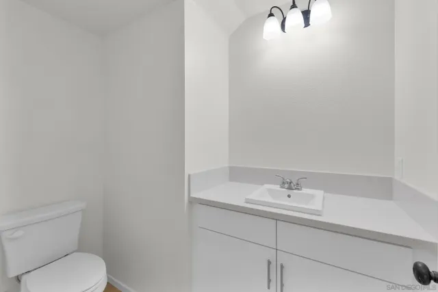 a bathroom with a sink a toilet and mirror