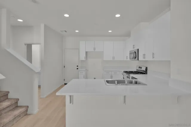 a kitchen with stainless steel appliances refrigerator sink and cabinets