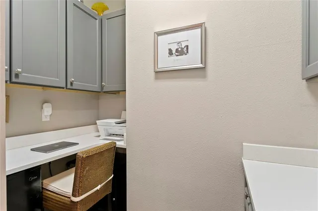 a bathroom with a granite countertop toilet sink and mirror
