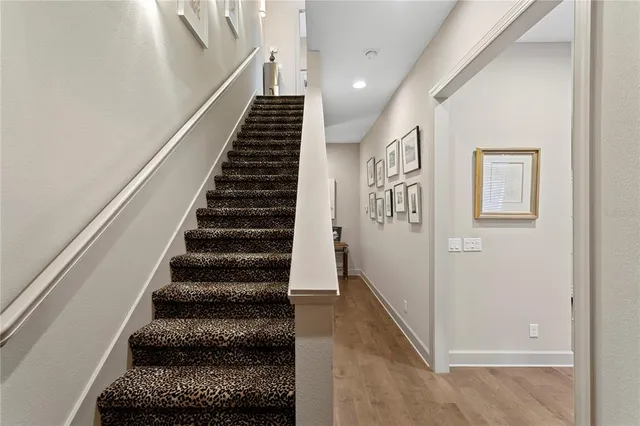 a view of a kitchen with kitchen island stainless steel appliances a sink and a living room view