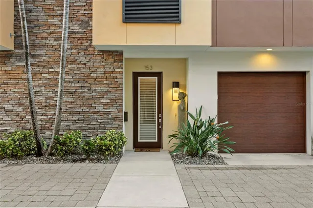 a front view of a house with a yard and a garage