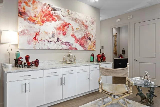 a view of a patio with a table and chairs under an umbrella