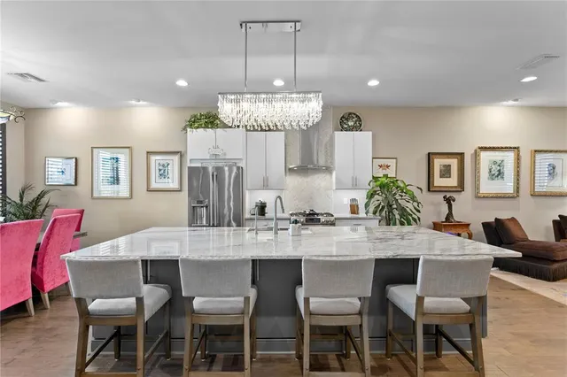 a view of a tables and chairs under an umbrella in patio