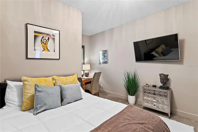 a bedroom with a bed and a night stand