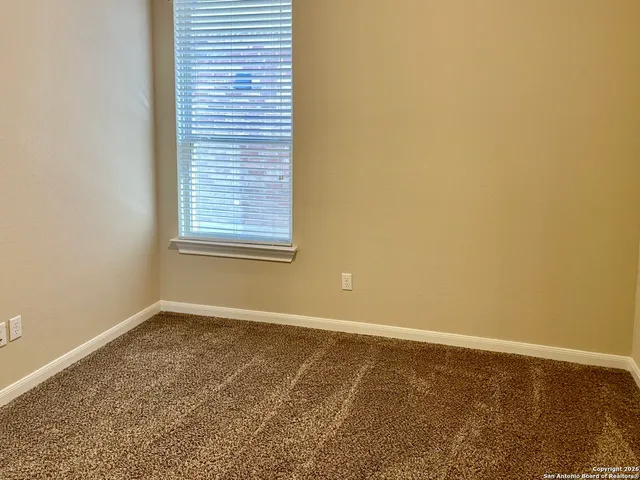 a bathroom with a shower and a window