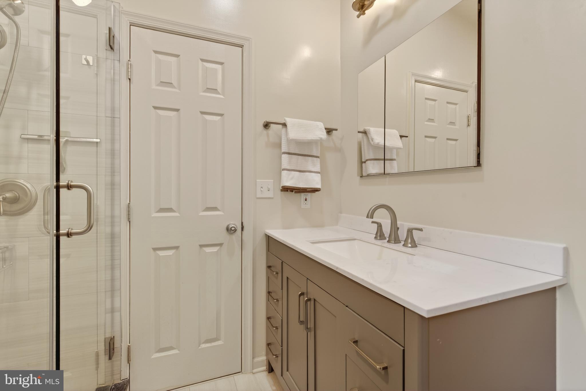 8901 Ellsworth Court Silver Spring, MD 20910 - Photo 33 of 43 a bathroom with a sink vanity and a mirror