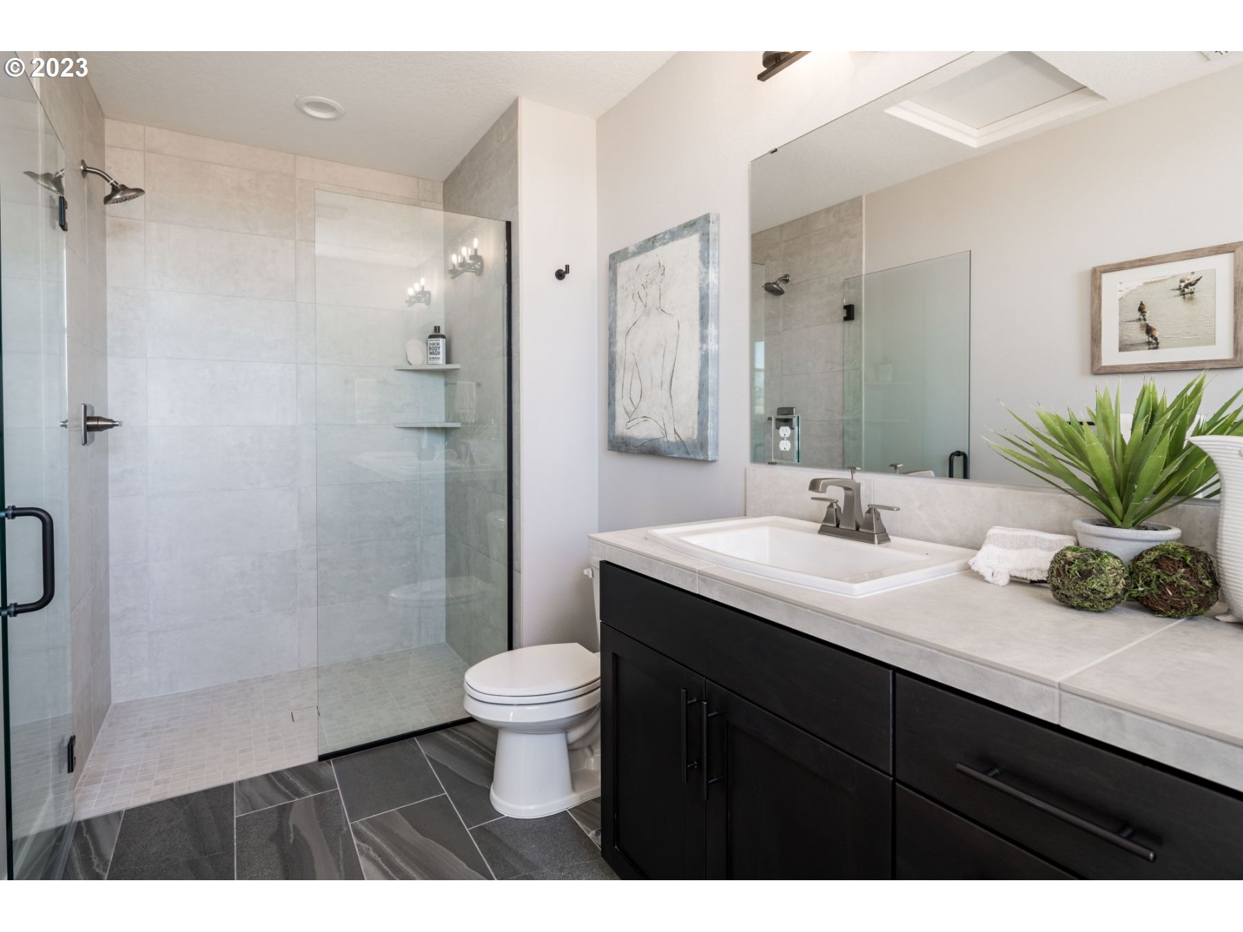 813 Northwest 178th Street Ridgefield, WA 98642 - Photo 12 of 21 a bathroom with a sink a toilet and shower