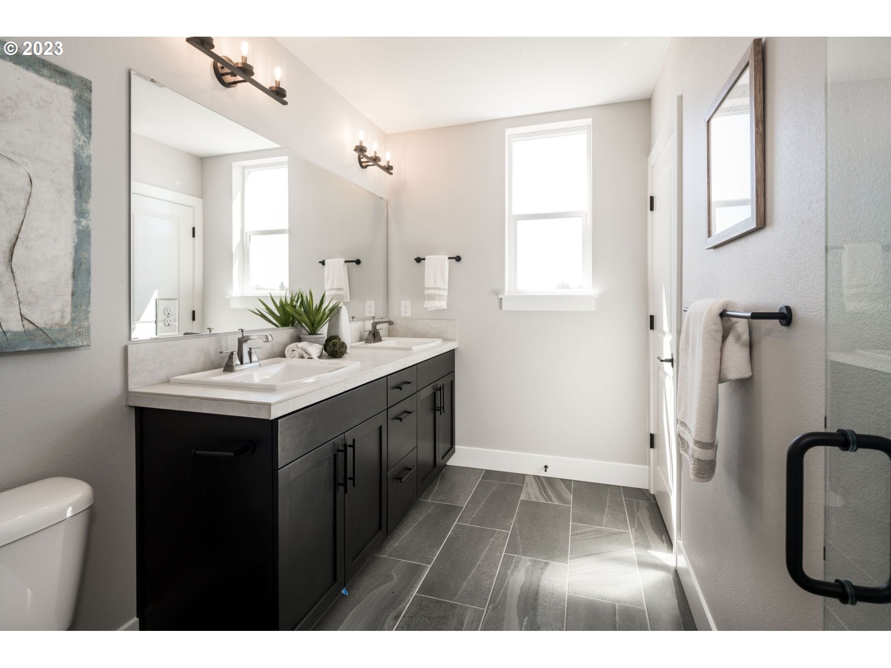 813 Northwest 178th Street Ridgefield, WA 98642 - Photo 13 of 21 a bathroom with a sink a toilet a mirror and shower