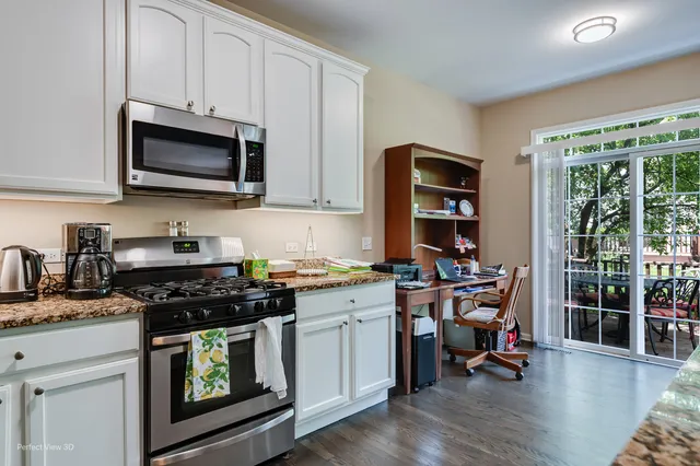 a kitchen with a stove a sink and a microwave