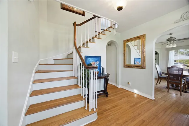 a view of entryway and hall with wooden floor