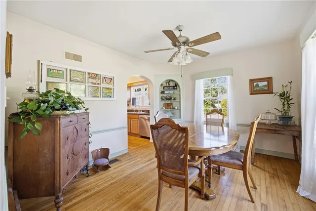 a view of a dining room with furniture and a potted plant