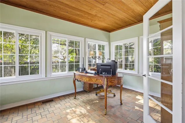 a view of a workspace with furniture and a window