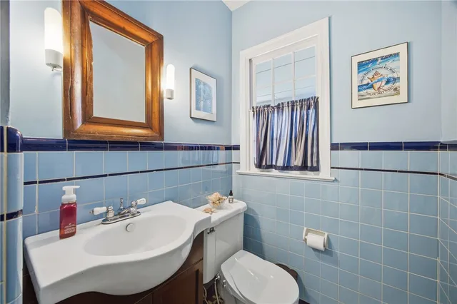a bathroom with a sink mirror and toilet