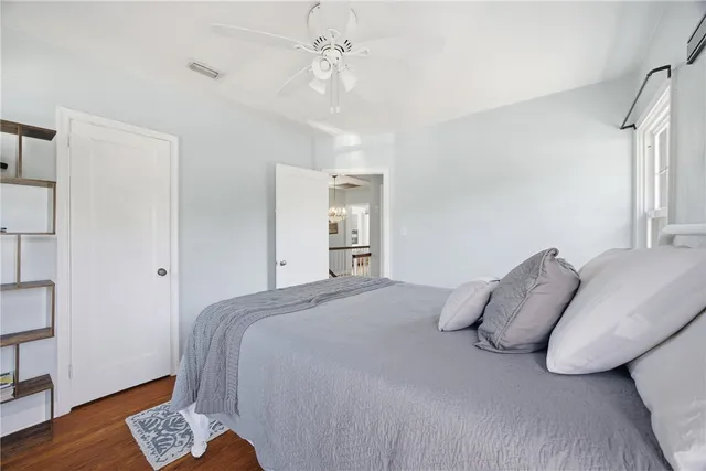 a bedroom with a bed and wooden floor