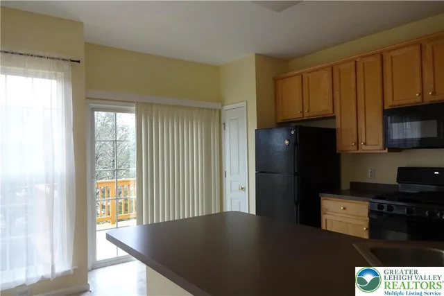 a stove top oven sitting inside of a kitchen
