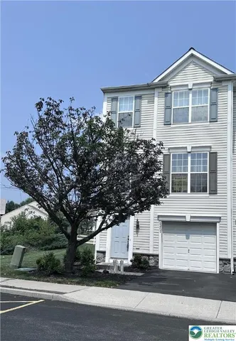 a view of a house with a tree