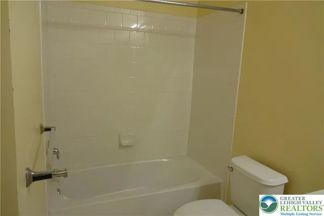 a bathroom with a shower and a toilet