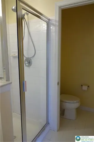 a bathroom with a toilet and a mirror
