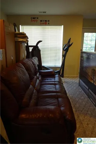 a living room with furniture fireplace and flat screen tv