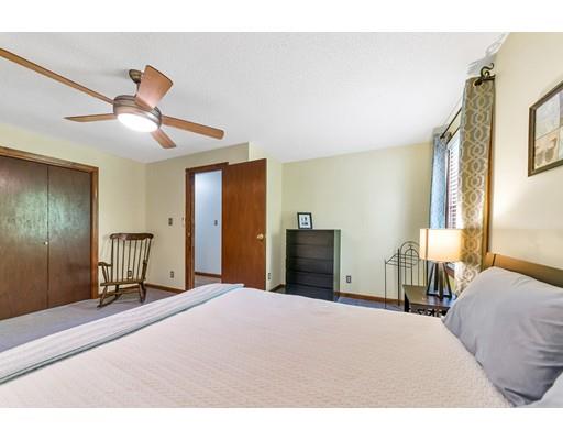 125 Thayer Road Monson, MA 01057 - Photo 17 of 30 a bedroom with a bed and a chandelier