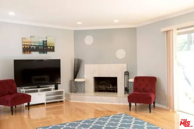 a living room with furniture flat screen tv and a fireplace